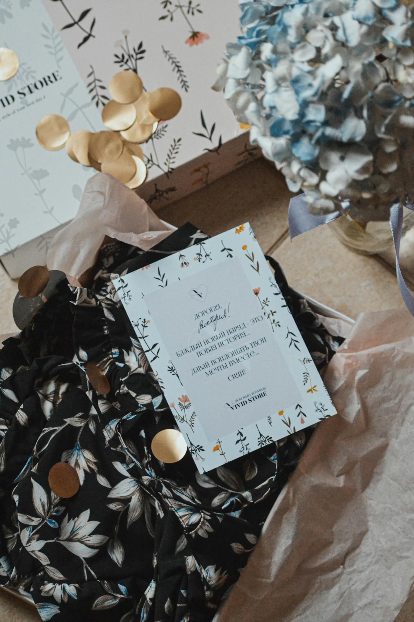 Top view of a floral design fabric and gift packaging with decorative notes.